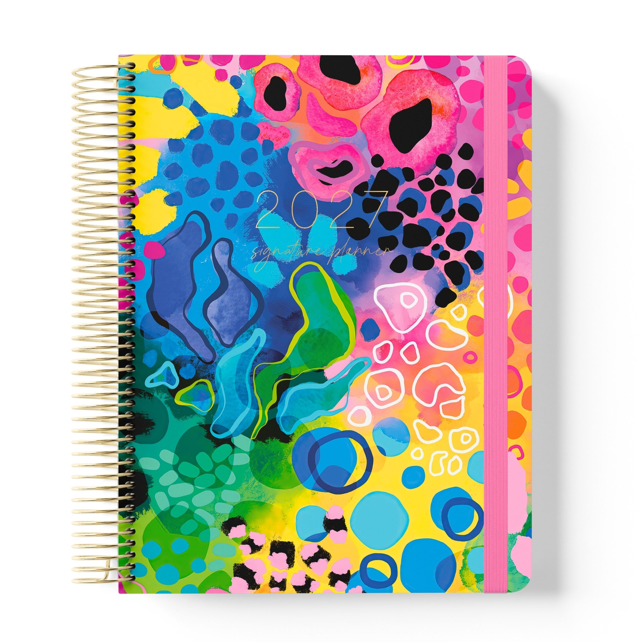 2027 Signature Planner in Boom with bold abstract artwork in pink, yellow, blue and green, gold coil and pink elastic closure.