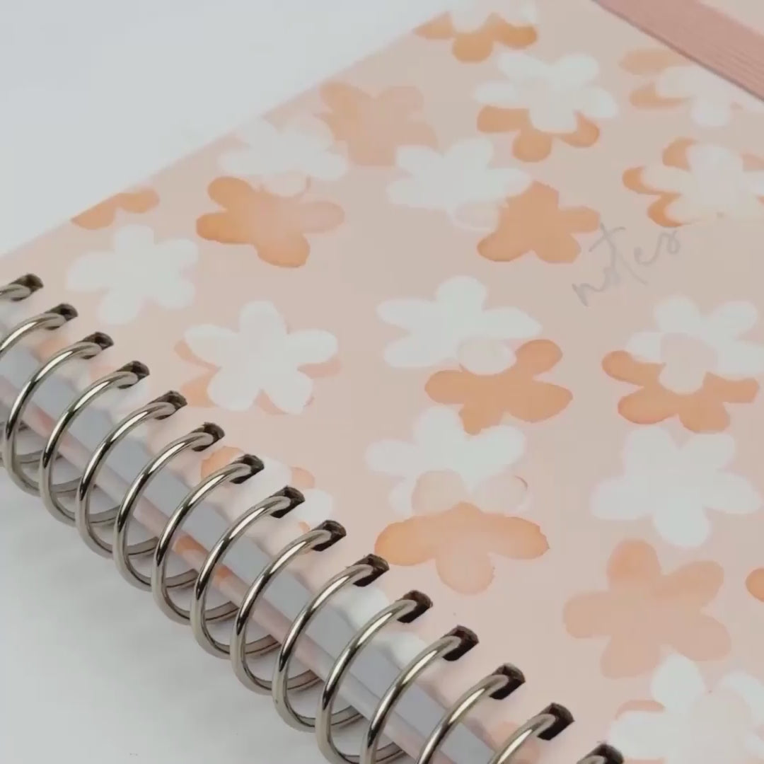 So Sweet notebook close up video showing off the white, orange floral designs with a pale orange background