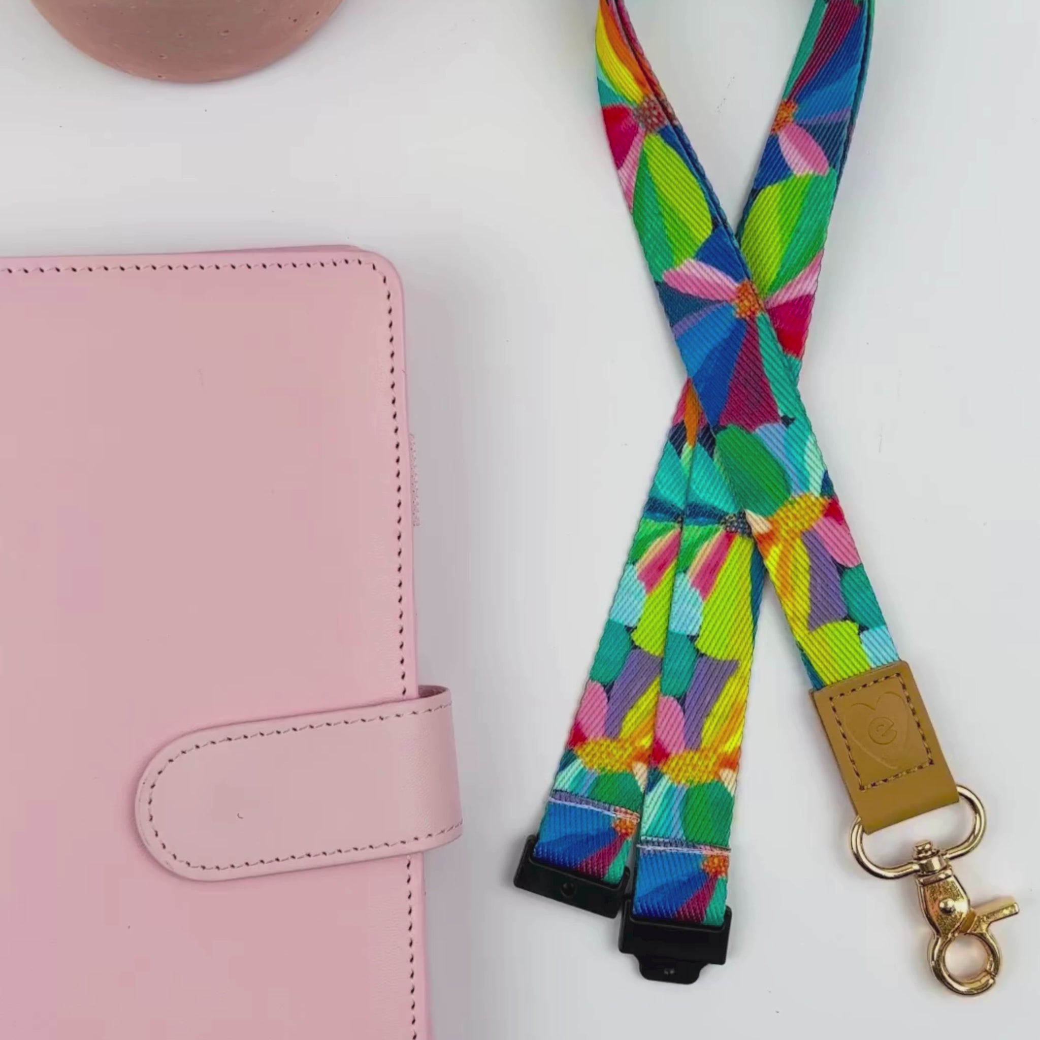 Teacher showcases Petal Party lanyard with vibrant floral design, sturdy gold clasp, and tan leather accent details.