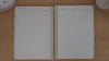 Neutrals teacher planner term overview pages shown in a flip-through
