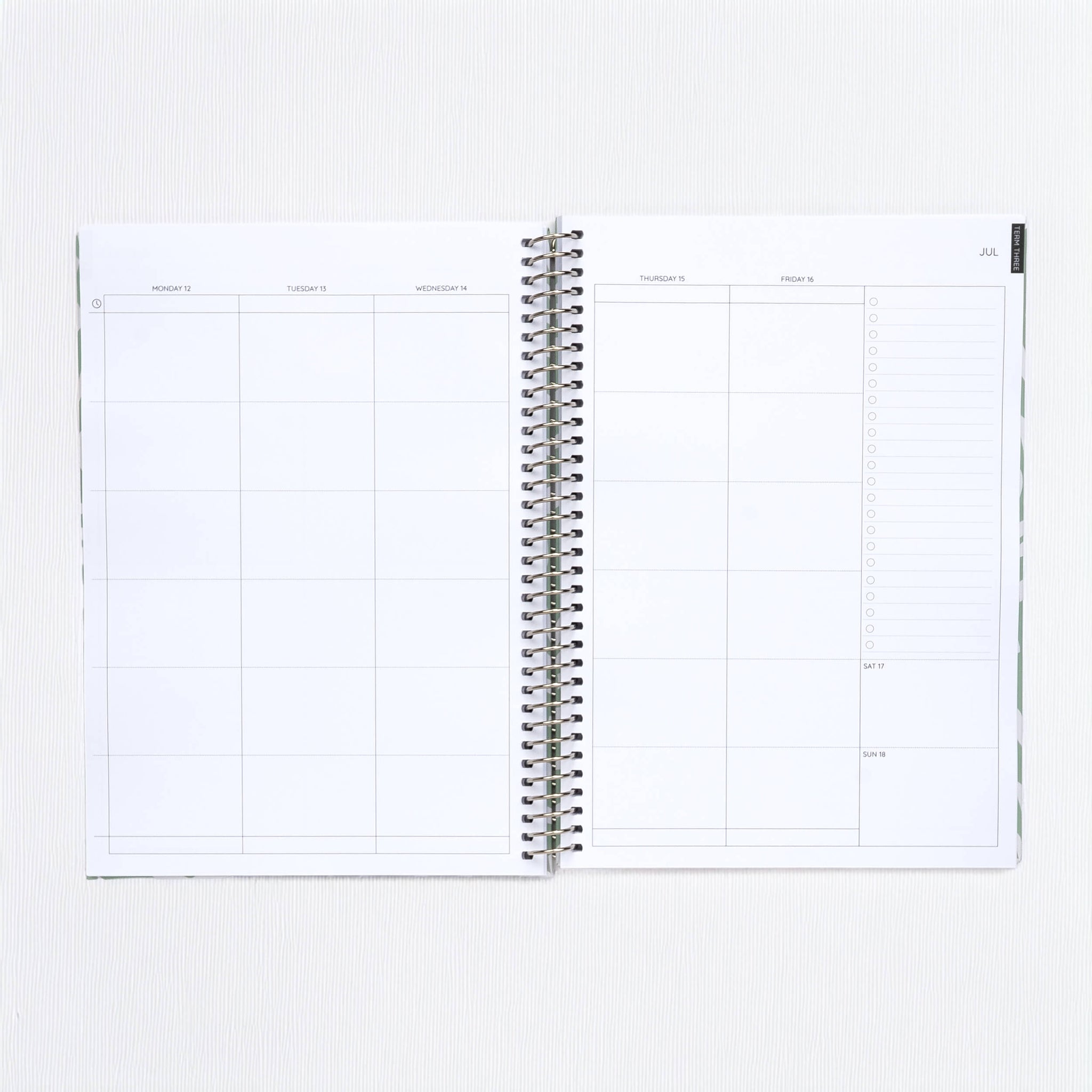 Open spiral-bound planner on a white background