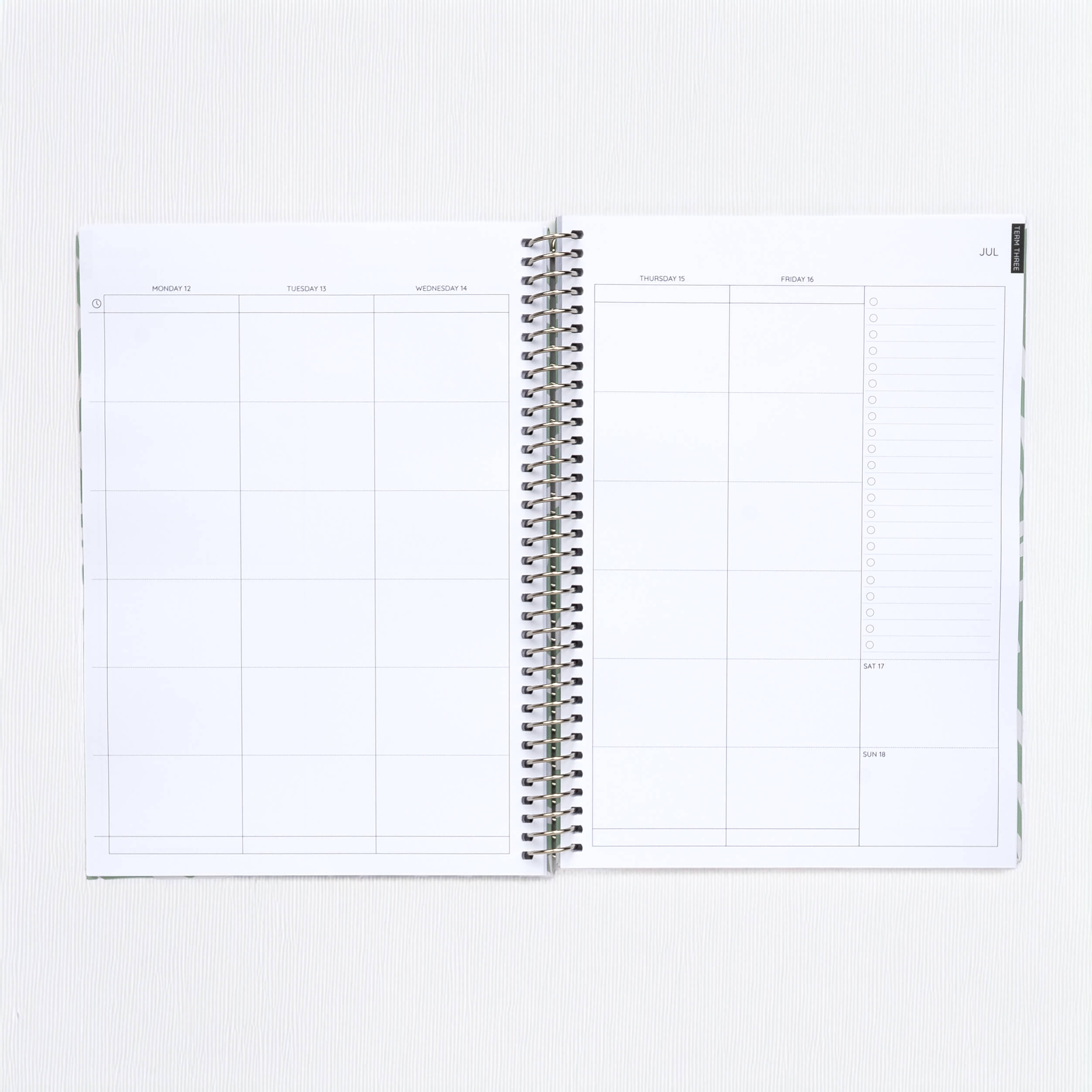Open spiral-bound planner on a white background