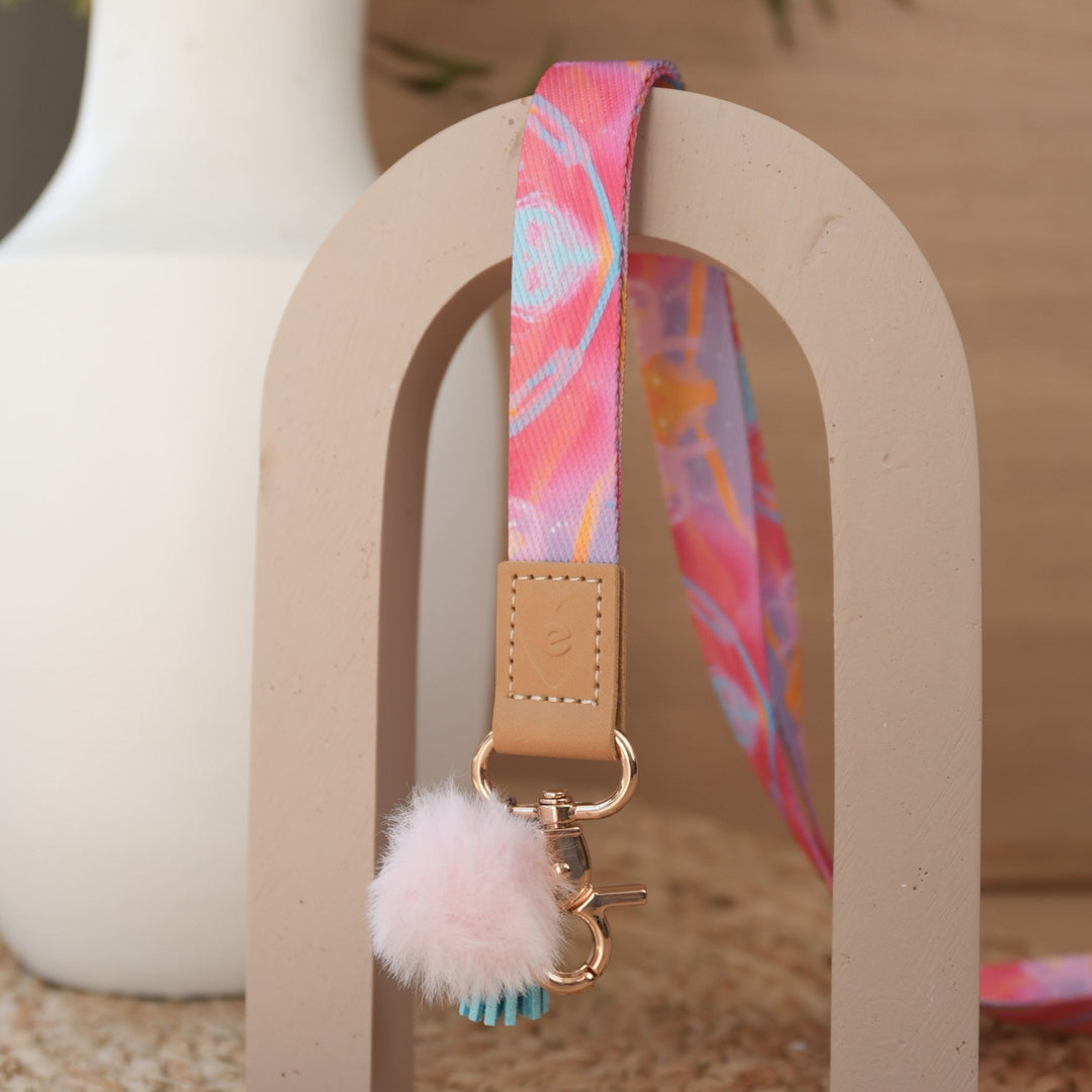 Solar Glow teacher lanyard by Rowena Martinich full length, gold clasp, baby pink pom pom and sky blue tassel