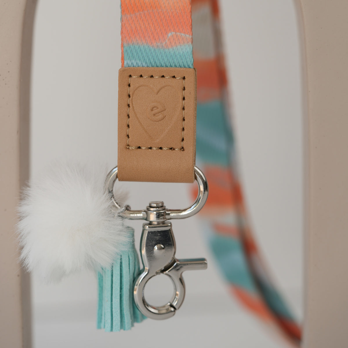 Detail of Walking With the Stars teacher lanyard clasp, silver hardware, mint pom pom and lilac tassel